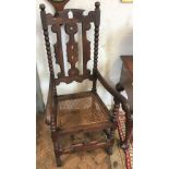 A pair of 17th century style stained beech Carolean hall chairs with caned seat below a pierced