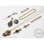 An assorted collection of jewellery, to include; a tie pin in the form of a sword hilt,