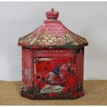 A cast iron letter box, decorated with a postman on horseback,