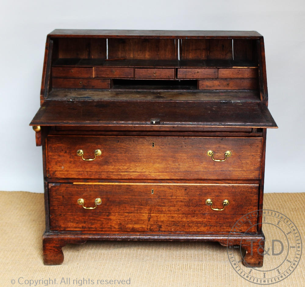 A George III provincial oak bureau, with fall over three long drawers, on bracket feet, - Image 2 of 2