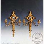 A pair of George III style gilt metal three branch wall lights,