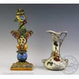 A Cantagalli Maiolica faience candlestick, modelled with a griffin, on square base, 33cm high,