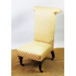 A Victorian mahogany prie-dieu chair, with foliate yellow upholstery, on turned legs,