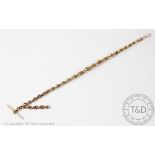 A 9ct rose gold Albertina, with fancy link chain and attached T bar and lobster clasp, 34cm long,