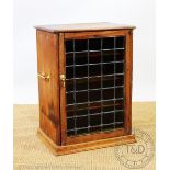 A pine cupboard, with stained glass door, and brass side handles,