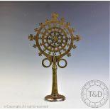 An Ethiopian processional cross, of circular form with pierced and engraved detailing,
