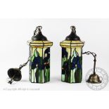 A pair of stained glass ceiling lights, decorated with iris,