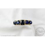 A five stone untested sapphire set ring, the five graduated untested sapphires,