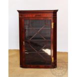 A George III style inlaid mahogany corner cabinet, with astragal glazed door,