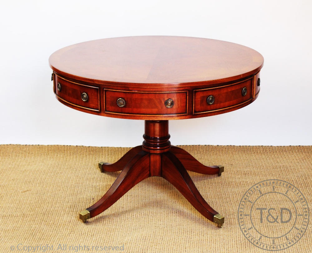 A Regency style reproduction mahogany circular drum table, with four real and four dummy drawers,