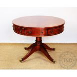 A Regency style reproduction mahogany circular drum table, with four real and four dummy drawers,
