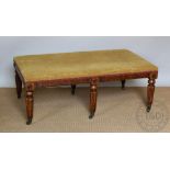 A William IV style oak foot stool of country house proportions, with patterned upholstery,