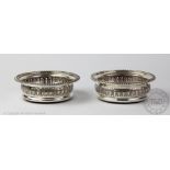 A pair of silver bottle coasters, Barker Ellis Silver Co, Birmingham 1972,