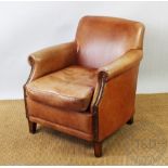 A modern tan leather armchair, possibly Multiyork, on tapered legs,
