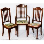 A part set of five Edwardian oak dining chairs, with drop in seats, on tapered square legs,