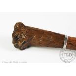 An early 20th century Black Forest type walking cane, the top modelled as a dog's head,