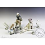 A Llaadro model of a recumbent clown, No 16, 37cm, with a Lladro maid and ducks group,