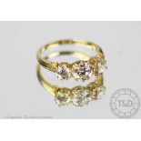 A three stone diamond ring, the three graduated, old brilliant cut diamonds,
