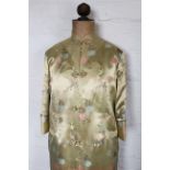 A Chinese silk day robe, worked with flowers against a golden coloured ground,