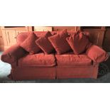 A country house three seater settee, with red upholstery,