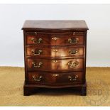 A George III style serpentine mahogany chest, with brush slide and four graduated long drawers,
