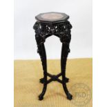 A late 19th century Chinese carved hardwood jardiniere stand, with inset marble top,