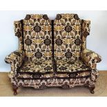 A late 17th century style wing back settee, early 20th century,