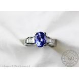 A tanzanite and diamond ring, the central tanzanite (measuring approx 2.