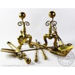 A pair of Victorian brass fire dogs, with ball finals and scroll detailing, on paw feet, 34cm H,