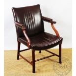 An early 20th century mahogany Gainsborough type library chair, with faux leather upholstery,