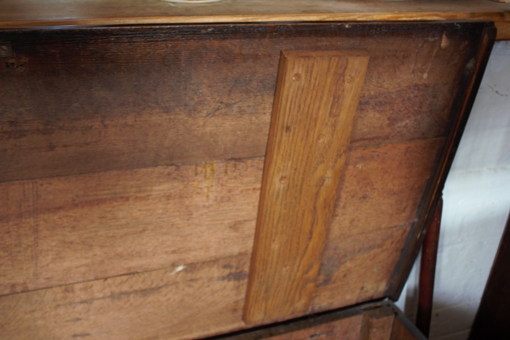 An 18th century oak coffer, with carved and panelled front, on stile legs, - Image 4 of 12