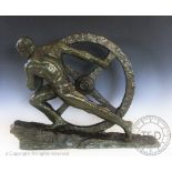 Pierre Le Faguays (French 1892-1962) a bronze sculpture of a man pulling a wheel up a slope,