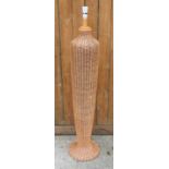 A modern woven wicker standard lamp, of baluster form, on circular base,