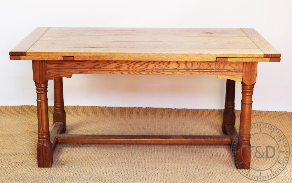 An oak drawer leaf extending refectory table, with five plank top, on turned legs and block feet,