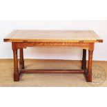 An oak drawer leaf extending refectory table, with five plank top, on turned legs and block feet,