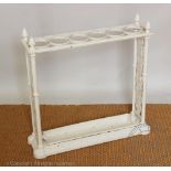 A Coalbrookdale style cast iron umbrella stand, with four circular sections, on plinth base,