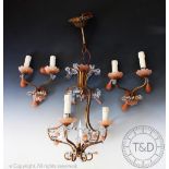 A French style gilt brass and moulded pink glass four branch ceiling light, hung with lustre drops,