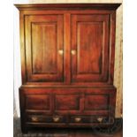 A George III oak livery cupboard, with two panelled doors enclosing hanging pegs,