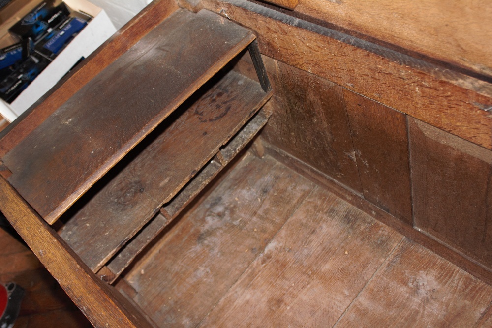 An 18th century oak coffer, with carved and panelled front, on stile legs, - Image 7 of 12