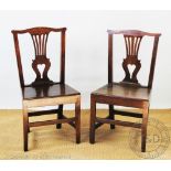 A set of six George III and later oak country kitchen chairs, with pierced splats and solid seats,