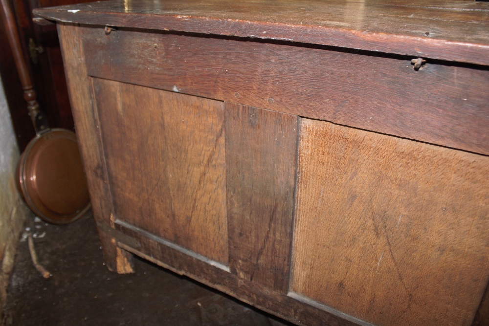 An 18th century oak coffer, with carved and panelled front, on stile legs, - Image 11 of 12