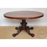 An early Victorian mahogany oval loo / breakfast table, with carved column and platform,