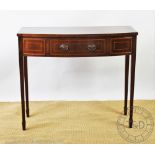 An Edwardian inlaid mahogany bow front side table, of tall proportions, with drawer,
