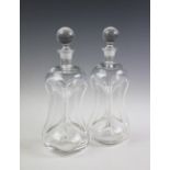 A pair of 19th century clear glass glug-glug decanters,