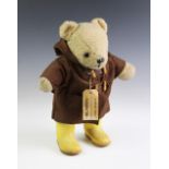 A plush teddy bear dressed in Paddington attire