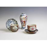 A pair of Chinese porcelain Batavian ware cups and saucers,