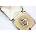 A Victorian heart shaped memorial brooch, designed as a central seed pearl floral cluster