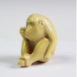 A Royal Worcester Blush Ivory model of a seated monkey,