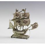 A white metal model of a galleon,