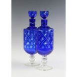 A near pair of Bohemian blue flashed glass decanters,